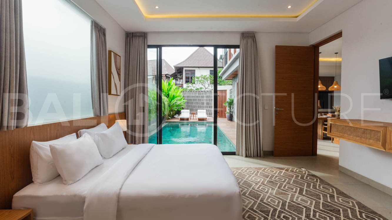 Four-bedroom furnished villa in Padonan, Canggu, featuring three bathrooms, a guest powder room, a private swimming pool, a spacious terrace, a balcony, and flexible indoor-outdoor living spaces, available on a 26-year leasehold.