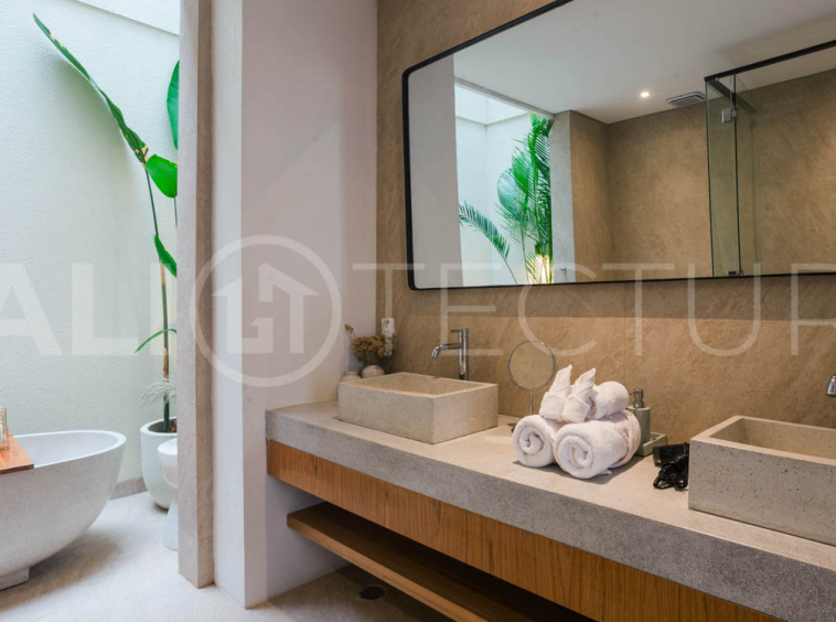 Four-bedroom furnished villa in Padonan, Canggu, featuring three bathrooms, a guest powder room, a private swimming pool, a spacious terrace, a balcony, and flexible indoor-outdoor living spaces, available on a 26-year leasehold.