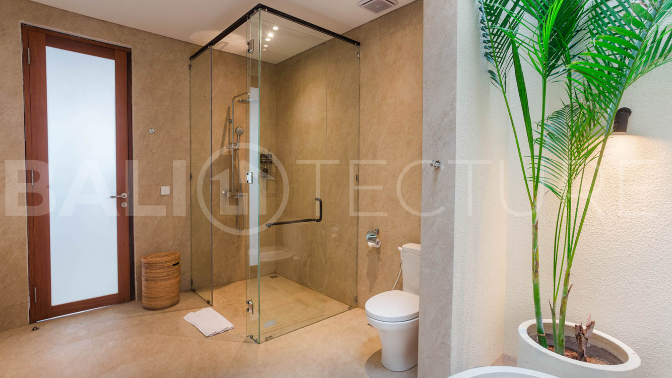 Four-bedroom furnished villa in Padonan, Canggu, featuring three bathrooms, a guest powder room, a private swimming pool, a spacious terrace, a balcony, and flexible indoor-outdoor living spaces, available on a 26-year leasehold.