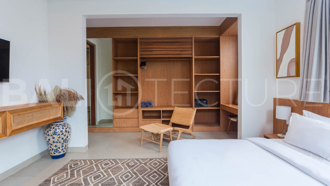 Four-bedroom furnished villa in Padonan, Canggu, featuring three bathrooms, a guest powder room, a private swimming pool, a spacious terrace, a balcony, and flexible indoor-outdoor living spaces, available on a 26-year leasehold.