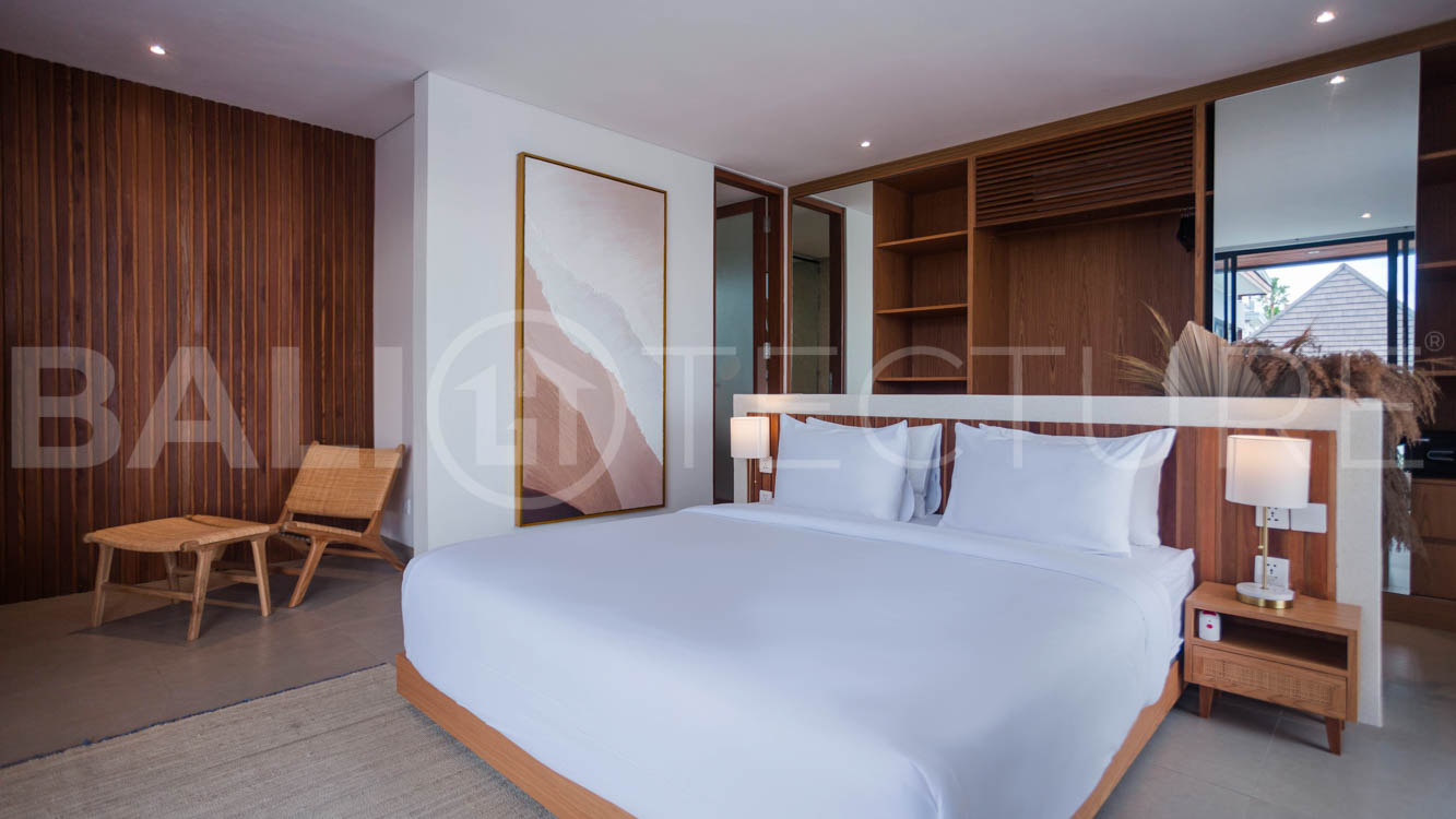 Four-bedroom furnished villa in Padonan, Canggu, featuring three bathrooms, a guest powder room, a private swimming pool, a spacious terrace, a balcony, and flexible indoor-outdoor living spaces, available on a 26-year leasehold.