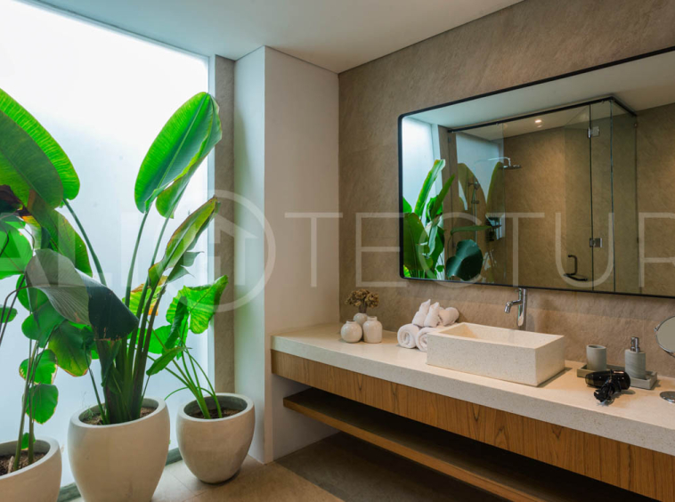 Four-bedroom furnished villa in Padonan, Canggu, featuring three bathrooms, a guest powder room, a private swimming pool, a spacious terrace, a balcony, and flexible indoor-outdoor living spaces, available on a 26-year leasehold.