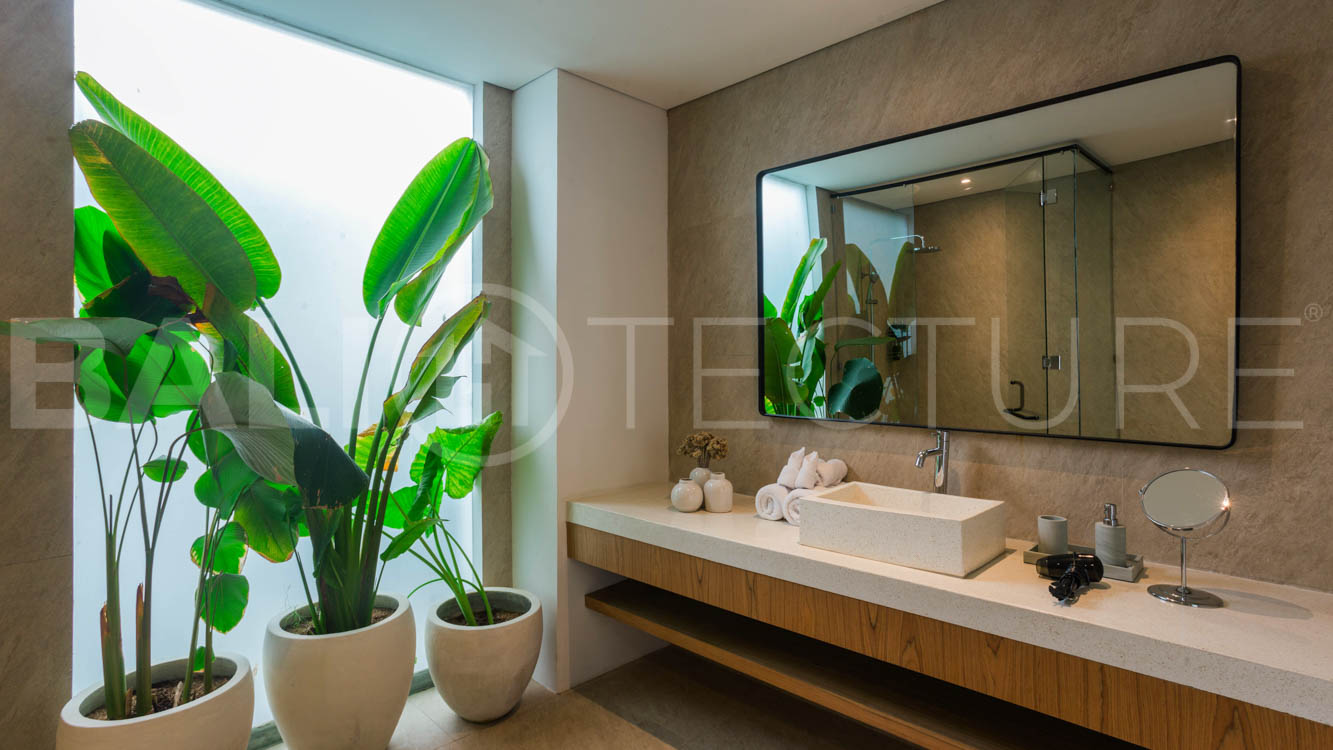 Four-bedroom furnished villa in Padonan, Canggu, featuring three bathrooms, a guest powder room, a private swimming pool, a spacious terrace, a balcony, and flexible indoor-outdoor living spaces, available on a 26-year leasehold.