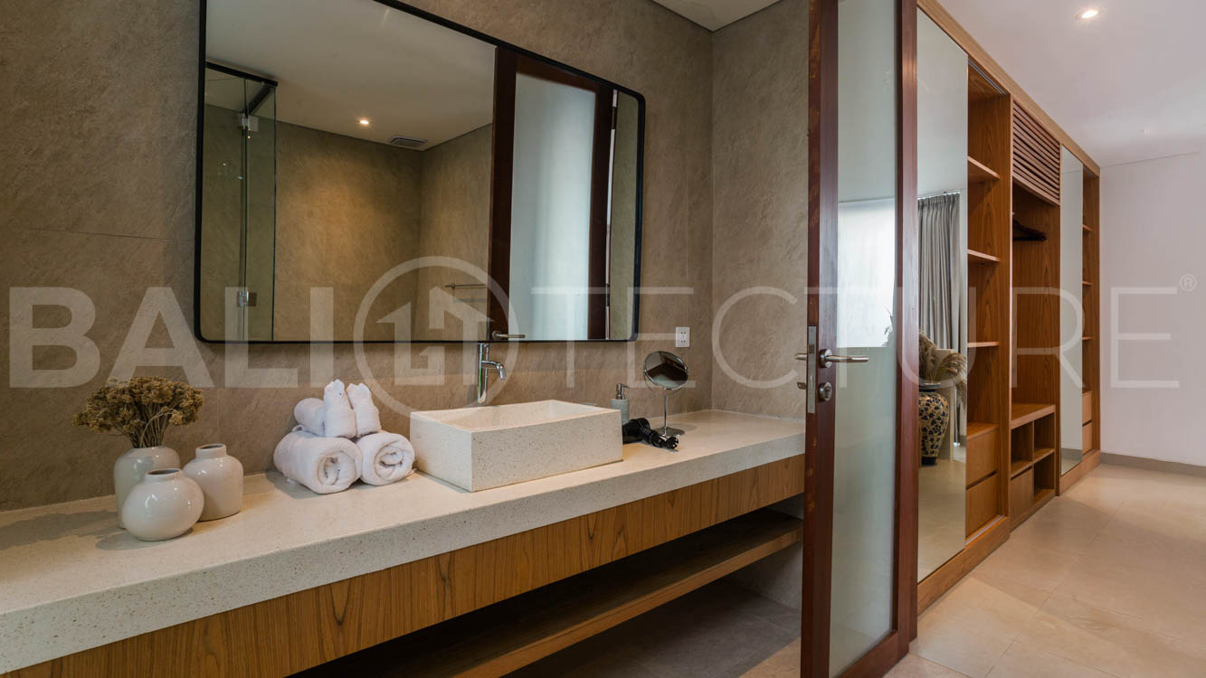 Four-bedroom furnished villa in Padonan, Canggu, featuring three bathrooms, a guest powder room, a private swimming pool, a spacious terrace, a balcony, and flexible indoor-outdoor living spaces, available on a 26-year leasehold.