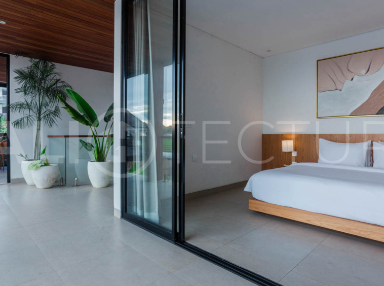 Four-bedroom furnished villa in Padonan, Canggu, featuring three bathrooms, a guest powder room, a private swimming pool, a spacious terrace, a balcony, and flexible indoor-outdoor living spaces, available on a 26-year leasehold.