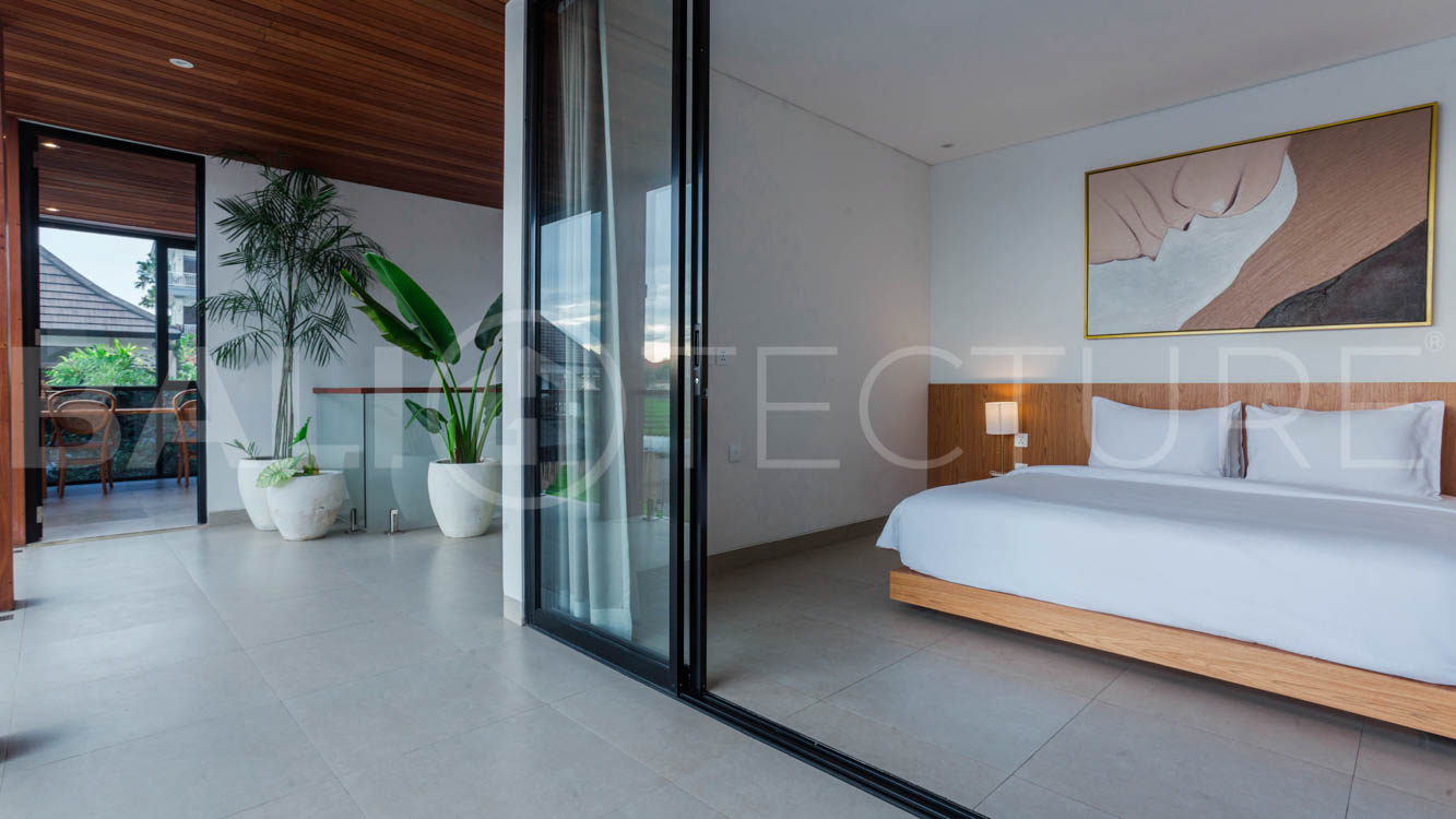 Four-bedroom furnished villa in Padonan, Canggu, featuring three bathrooms, a guest powder room, a private swimming pool, a spacious terrace, a balcony, and flexible indoor-outdoor living spaces, available on a 26-year leasehold.