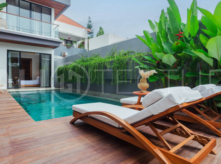 Four-bedroom furnished villa in Padonan, Canggu, featuring three bathrooms, a guest powder room, a private swimming pool, a spacious terrace, a balcony, and flexible indoor-outdoor living spaces, available on a 26-year leasehold.