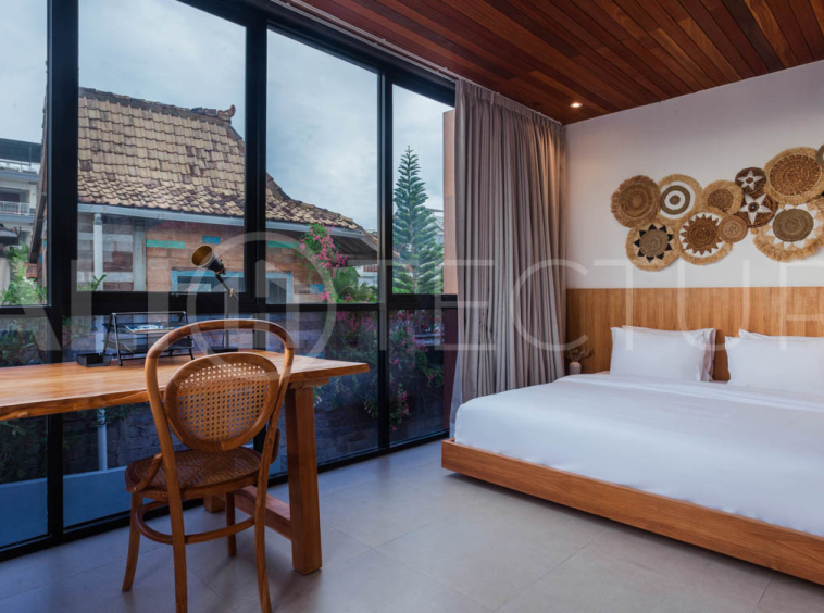 Four-bedroom furnished villa in Padonan, Canggu, featuring three bathrooms, a guest powder room, a private swimming pool, a spacious terrace, a balcony, and flexible indoor-outdoor living spaces, available on a 26-year leasehold.