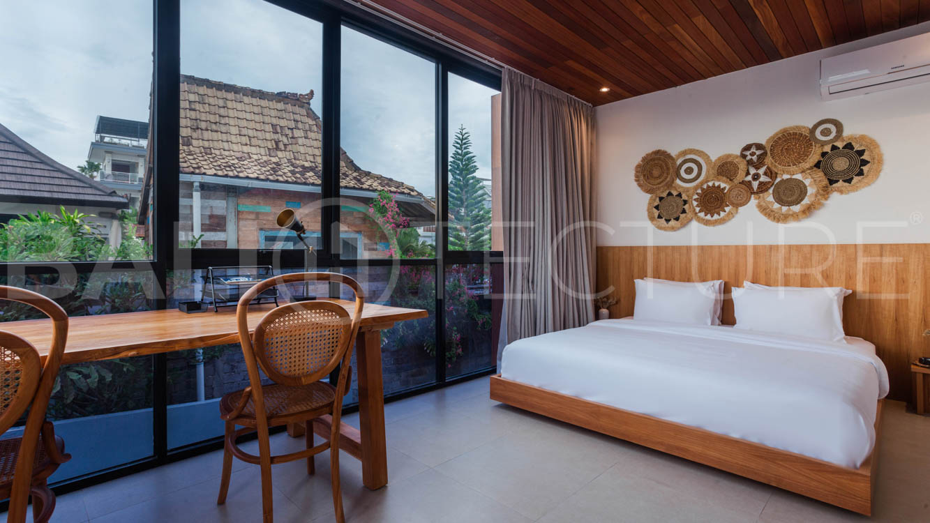 Four-bedroom furnished villa in Padonan, Canggu, featuring three bathrooms, a guest powder room, a private swimming pool, a spacious terrace, a balcony, and flexible indoor-outdoor living spaces, available on a 26-year leasehold.