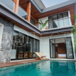 Four-bedroom furnished villa in Padonan, Canggu, featuring three bathrooms, a guest powder room, a private swimming pool, a spacious terrace, a balcony, and flexible indoor-outdoor living spaces, available on a 26-year leasehold.