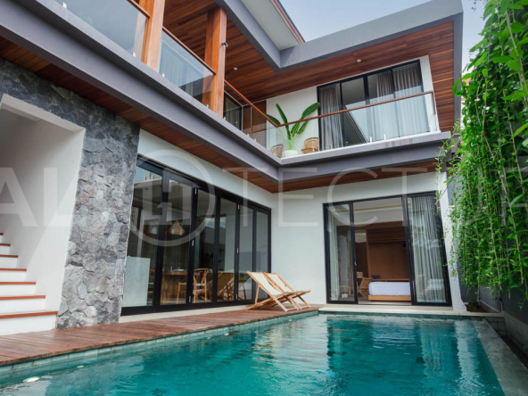 Four-bedroom furnished villa in Padonan, Canggu, featuring three bathrooms, a guest powder room, a private swimming pool, a spacious terrace, a balcony, and flexible indoor-outdoor living spaces, available on a 26-year leasehold.