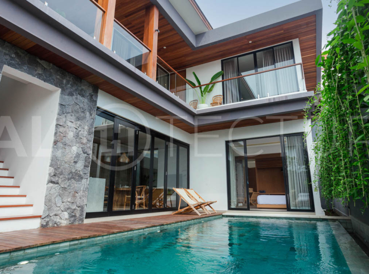 Four-bedroom furnished villa in Padonan, Canggu, featuring three bathrooms, a guest powder room, a private swimming pool, a spacious terrace, a balcony, and flexible indoor-outdoor living spaces, available on a 26-year leasehold.