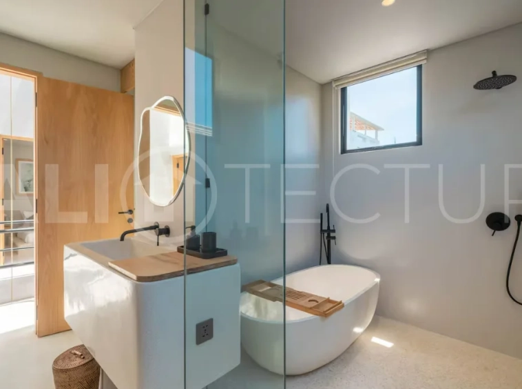 Luxury villa for sale in Canggu, featuring 590.8 m² of land, approximately 200 m² of building space, a lagoon shaped private swimming pool, tropical garden, modern interiors, private sauna, and a leasehold valid until May 2047 with an extension option.