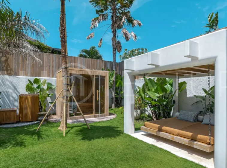 Luxury villa for sale in Canggu, featuring 590.8 m² of land, approximately 200 m² of building space, a lagoon shaped private swimming pool, tropical garden, modern interiors, private sauna, and a leasehold valid until May 2047 with an extension option.
