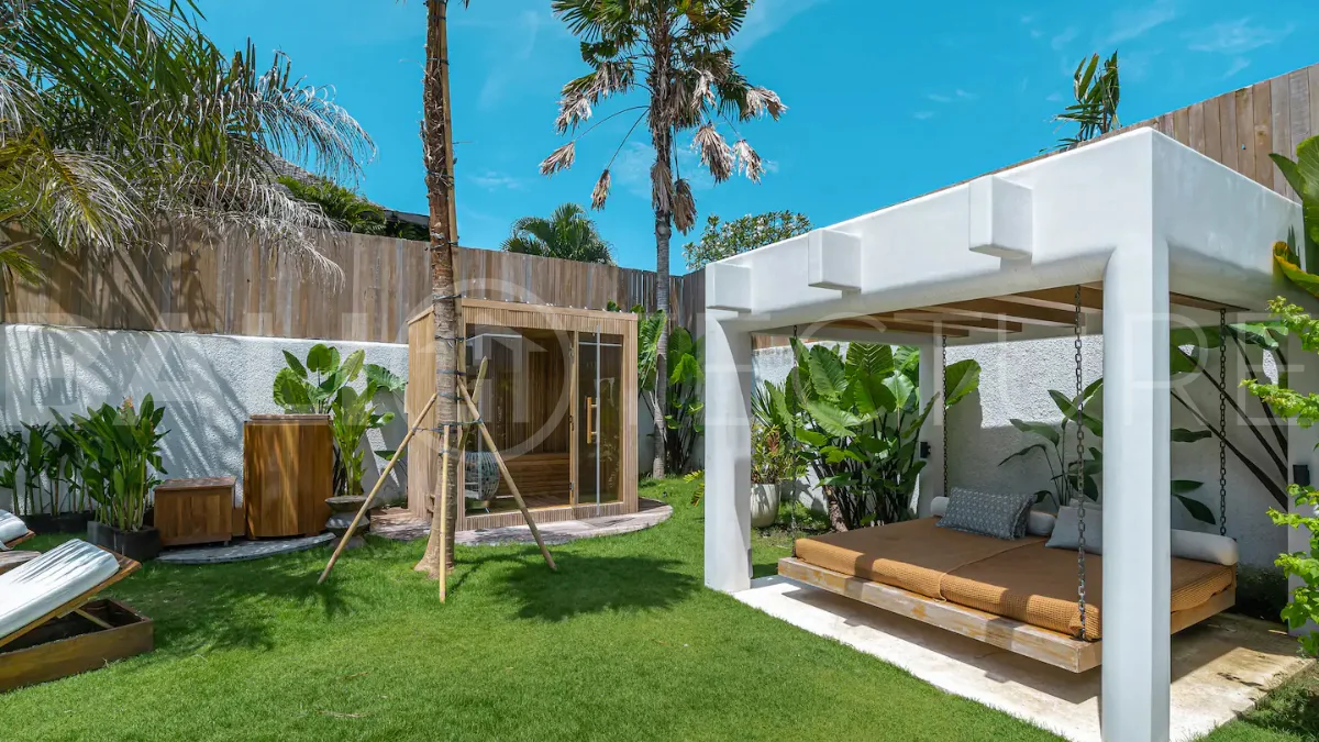Luxury villa for sale in Canggu, featuring 590.8 m² of land, approximately 200 m² of building space, a lagoon shaped private swimming pool, tropical garden, modern interiors, private sauna, and a leasehold valid until May 2047 with an extension option.