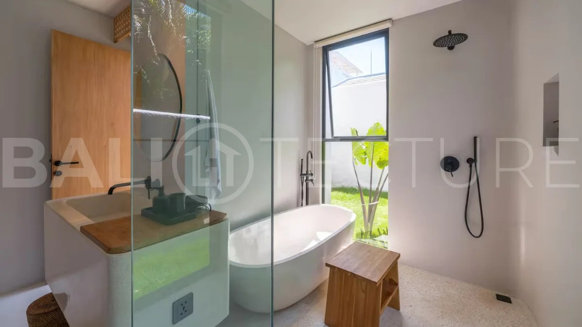 Luxury villa for sale in Canggu, featuring 590.8 m² of land, approximately 200 m² of building space, a lagoon shaped private swimming pool, tropical garden, modern interiors, private sauna, and a leasehold valid until May 2047 with an extension option.