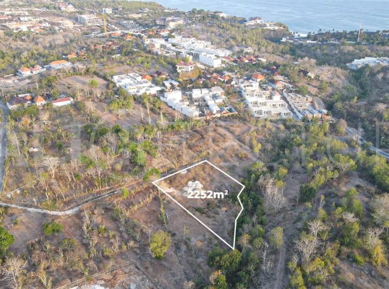 2,252 sqm touristic zoning land for sale in Melasti, South Bali, featuring a sloping landscape with lush jungle surroundings, 4-meter access road, and development potential near Melasti Beach.