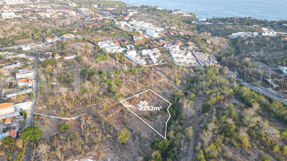 2,252 sqm touristic zoning land for sale in Melasti, South Bali, featuring a sloping landscape with lush jungle surroundings, 4-meter access road, and development potential near Melasti Beach.