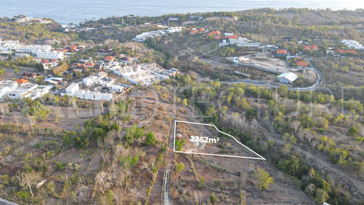 2,252 sqm touristic zoning land for sale in Melasti, South Bali, featuring a sloping landscape with lush jungle surroundings, 4-meter access road, and development potential near Melasti Beach.
