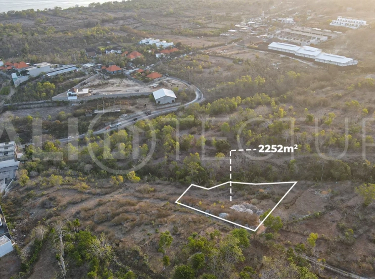 2,252 sqm touristic zoning land for sale in Melasti, South Bali, featuring a sloping landscape with lush jungle surroundings, 4-meter access road, and development potential near Melasti Beach.
