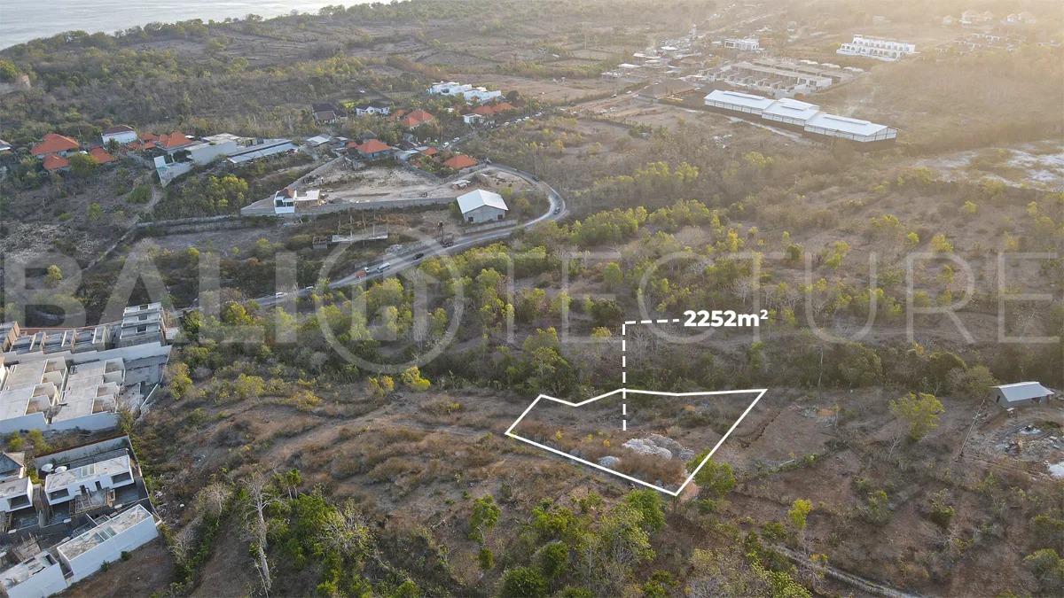 2,252 sqm touristic zoning land for sale in Melasti, South Bali, featuring a sloping landscape with lush jungle surroundings, 4-meter access road, and development potential near Melasti Beach.