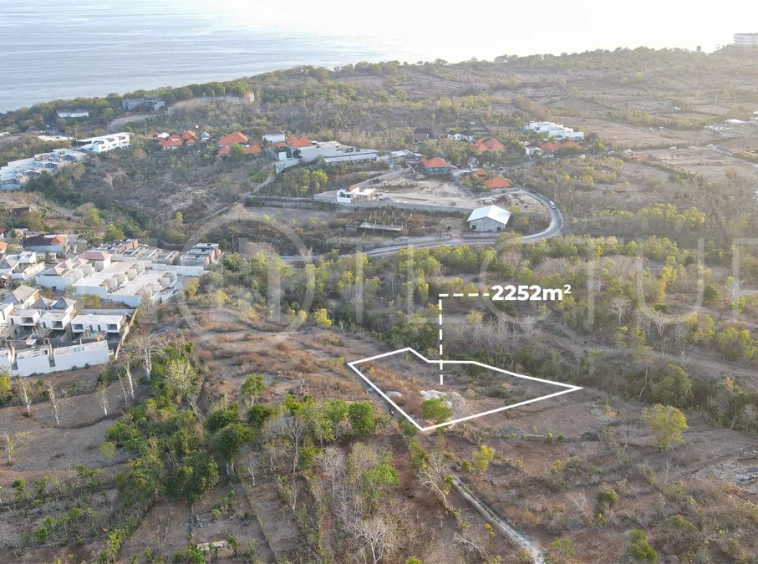 2,252 sqm touristic zoning land for sale in Melasti, South Bali, featuring a sloping landscape with lush jungle surroundings, 4-meter access road, and development potential near Melasti Beach.