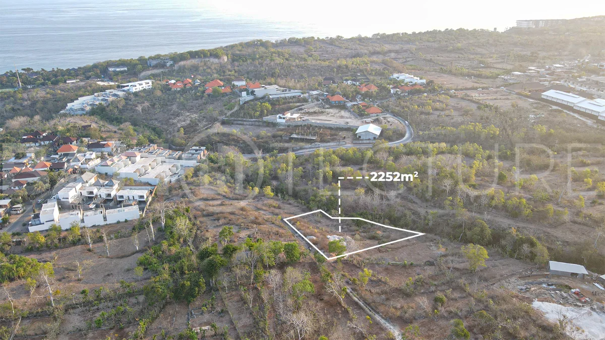 2,252 sqm touristic zoning land for sale in Melasti, South Bali, featuring a sloping landscape with lush jungle surroundings, 4-meter access road, and development potential near Melasti Beach.