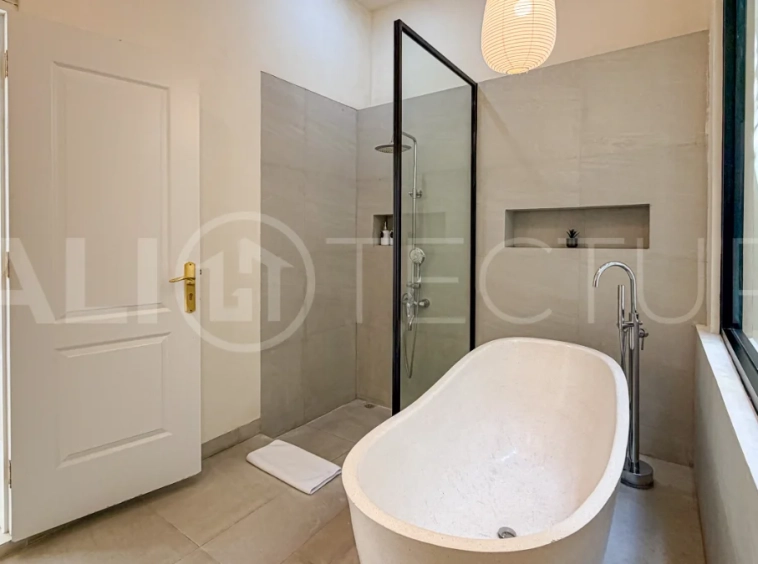 1-bedroom tropical villa for sale in Kayu Tulang, Canggu, featuring a private swimming pool, spacious bedroom, modern interiors, and a landscaped outdoor terrace.